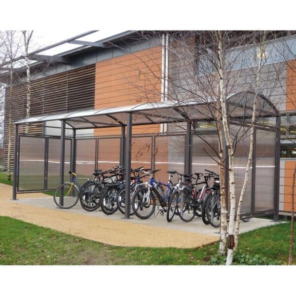 Photo de vélos rangés à des supports vélos sous un abri vélo voûte m gris étendu
